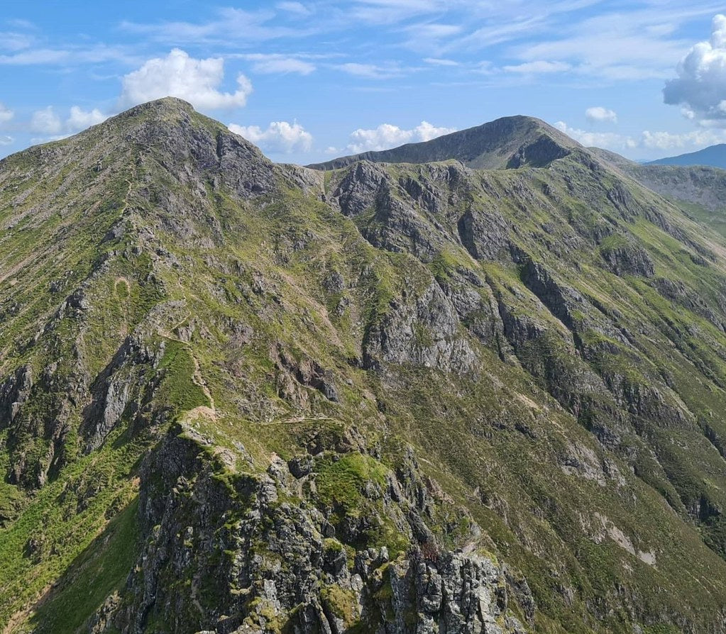 Green mountain ridge in Glencoe, Scottish Highlands, on a summer day